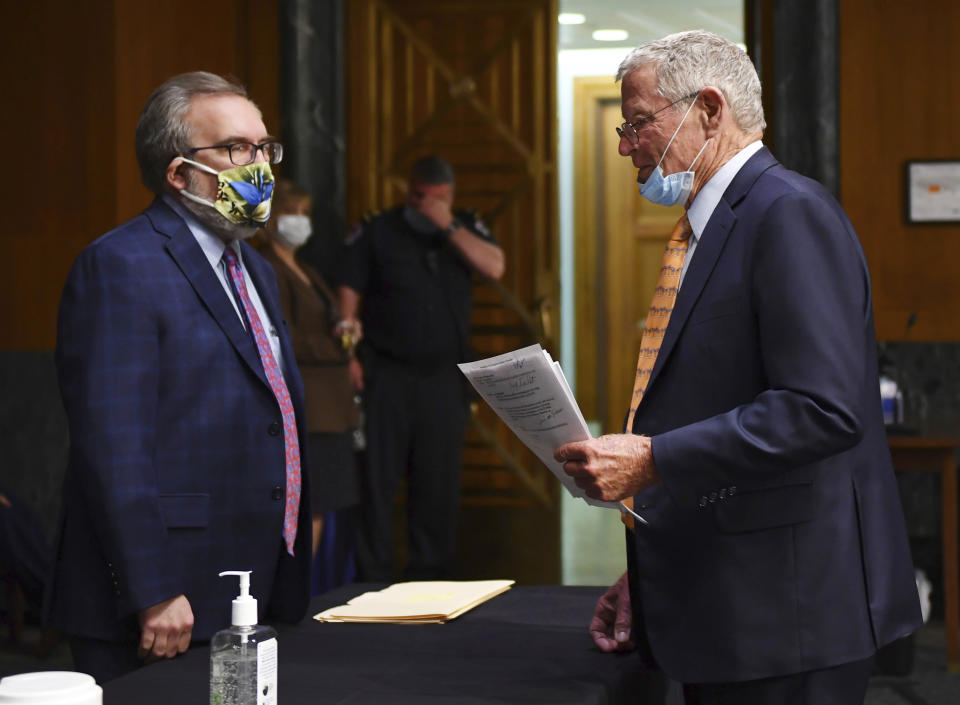 EPA Administrator Andrew Wheeler, left, speaks with Sen. James Inhofe, R-Okla., before opening remarks during a Senate Environment and Public Works Committee oversight hearing to examine the Environmental Protection Agency, Wednesday, May 20, 2020 on Capitol Hill in Washington. (Kevin Dietsch/Pool via AP)