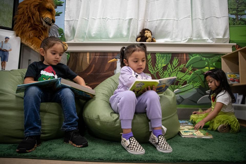 Three-year-old pre-k students from left, Raelyn Jaimes, Evelyn Reyna and Krizza Ybanez read at Menger Elementary School, on Wednesday, Dec. 21, 2022, in Corpus Christi, Texas. 