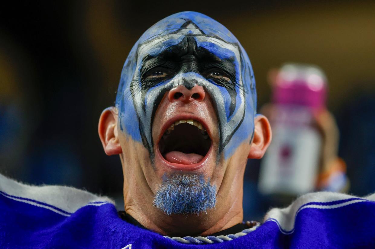 A Detroit Lions fan cheers from the stands during the third quarter of the wild-card round of the NFC playoffs against the L.A. Rams at Ford Field in Detroit on Sunday, Jan. 14, 2024.