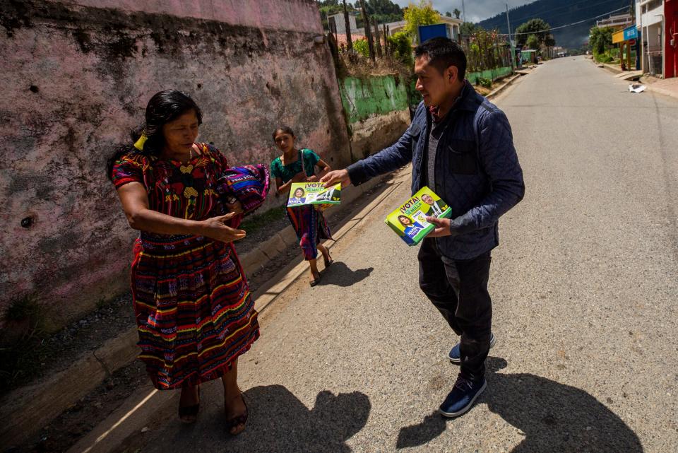 Bartolo Baten distributed political leaflets of Bernardo Arevalo seeking support from members of his Mayan community in Chiul, Guatemala on Aug. 13, 2023. Baten had presented the presidential candidate with a gift from the community in Quiche, Guatemala the previous day where the candidate held a rally ahead of the runoff election on Aug. 20, 2023.