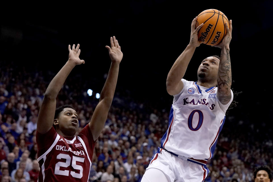 Kansas guard Bobby Pettiford Jr. (0) shoots over Oklahoma guard Grant Sherfield (25) during the first half of an NCAA college basketball game Tuesday, Jan. 10, 2023, in Lawrence, Kan. (AP Photo/Charlie Riedel)