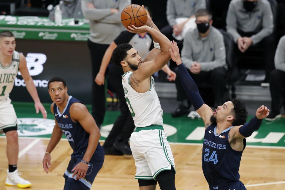 Boston Celtics' Jayson Tatum (0) shoots over Memphis Grizzlies' Dillon Brooks (24) during the first half of an NBA basketball game, Wednesday, Dec. 30, 2020, in Boston. (AP Photo/Michael Dwyer)