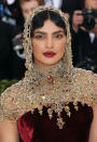 <p> We love it when the make-up pulls together an outfit, and Priyanka Chopra’s gold eyeshadow and dark red lip perfectly matched hers at the 2018 event—which had one of the most memorable Met Gala themes, “Heavenly Bodies: Fashion and the Catholic Imagination”. </p>