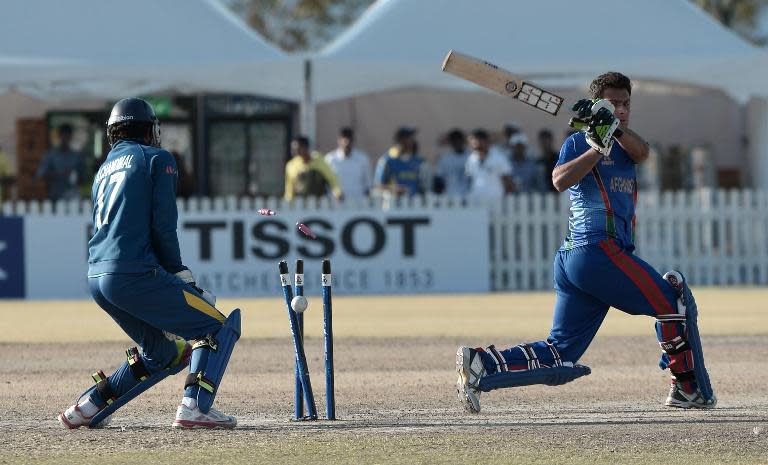 Afghanistan's Fareed Ahmad Walayat Khan (right) is dismissed during the Asian Games cricket final against Sri Lanka in Incheon on October 3, 2014
