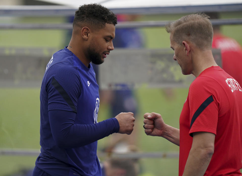 United States' goalkeeper Zack Steffen, left, greets a trainer during a training session ahead of the World Cup 2022 qualifying soccer match against Jamaica in Kingston, Monday, Nov. 15, 2021.(AP Photo/Fernando Llano)