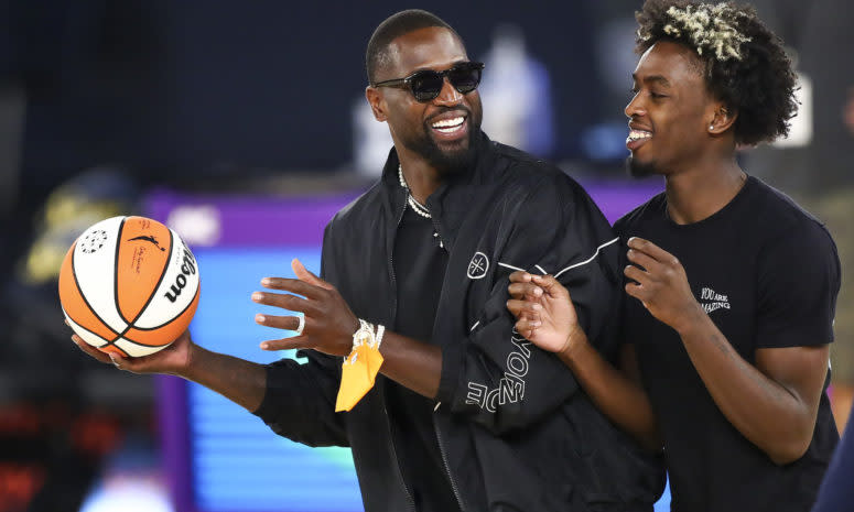 Dwyane Wade and his son, Zaire spend time on the court after a WNBA game.