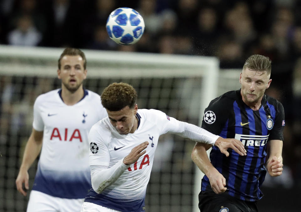 Tottenham midfielder Dele Alli, left, and Inter defender Milan Skriniar go for a header during a Champions League group B soccer match between Tottenham Hotspur and Inter Milan at Wembley stadium in London, Wednesday, Nov. 28, 2018. (AP Photo/Matt Dunham)