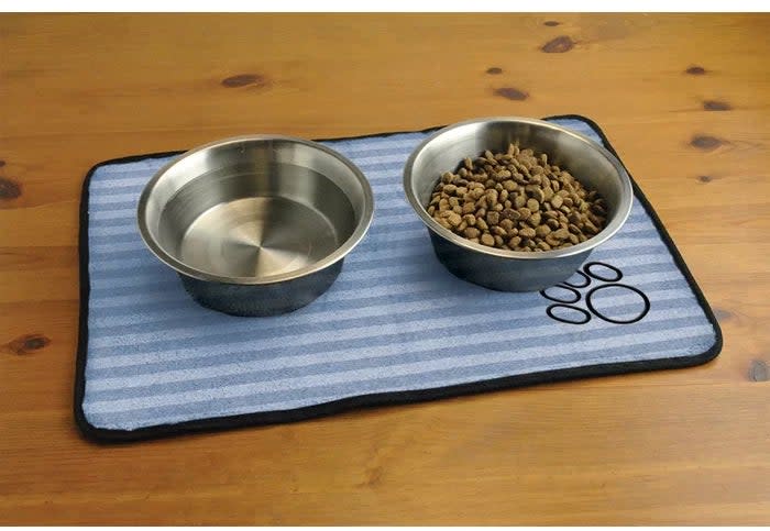 Two metal pet bowls on a striped mat, one filled with water and the other with kibble, featuring a paw print design