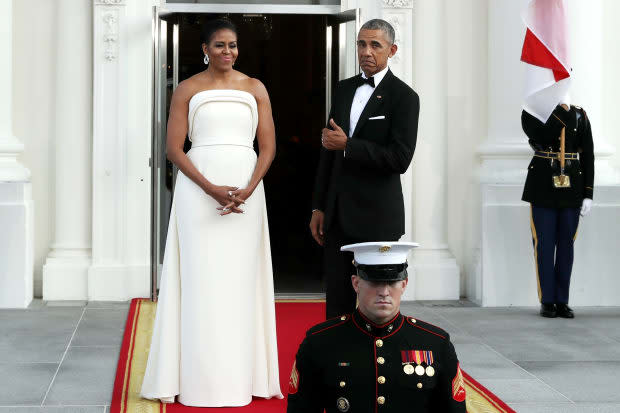 Michelle Obama, wearing Brandon Maxwell, and former president Barack Obama, approving of the look, at a 2016 Singapore State Dinner.