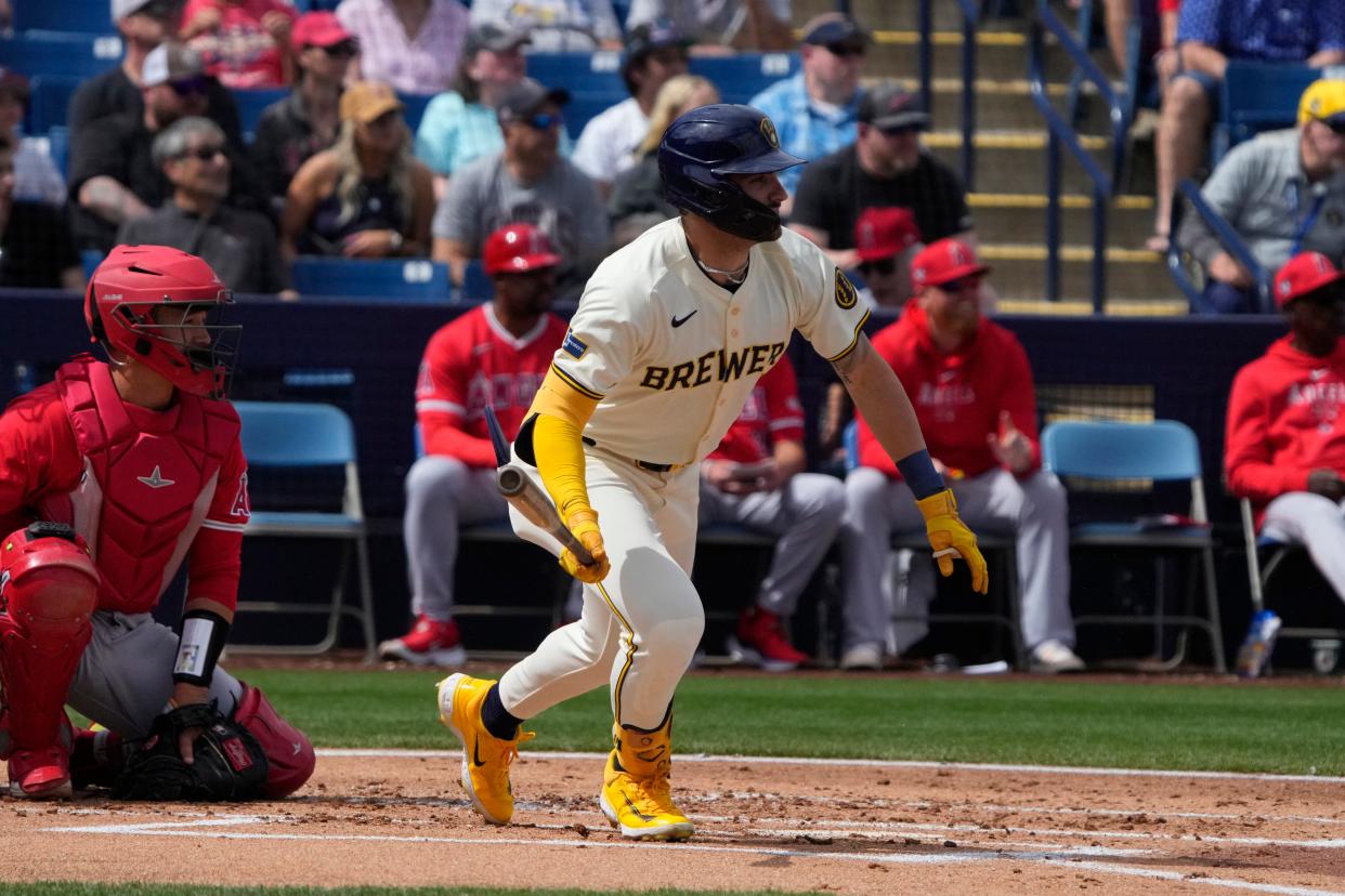 Mar 18, 2024; Phoenix, Arizona, USA; Milwaukee Brewers center fielder Garrett Mitchell (5) hits a single against the Los Angeles Angels in the first inning at American Family Fields of Phoenix. Mandatory Credit: Rick Scuteri-USA TODAY Sports