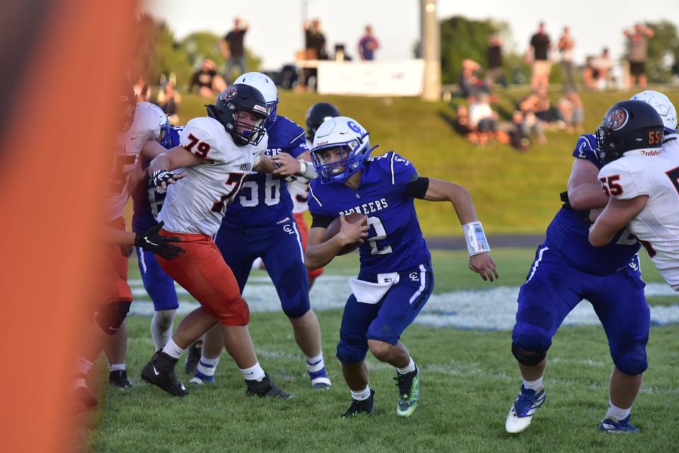 Croswell-Lexington's Gavin Espinoza runs through a hole during a game earlier this season. The quarterback threw four touchdown passes in the Pioneers' 32-29 overtime victory against Yale on Friday.