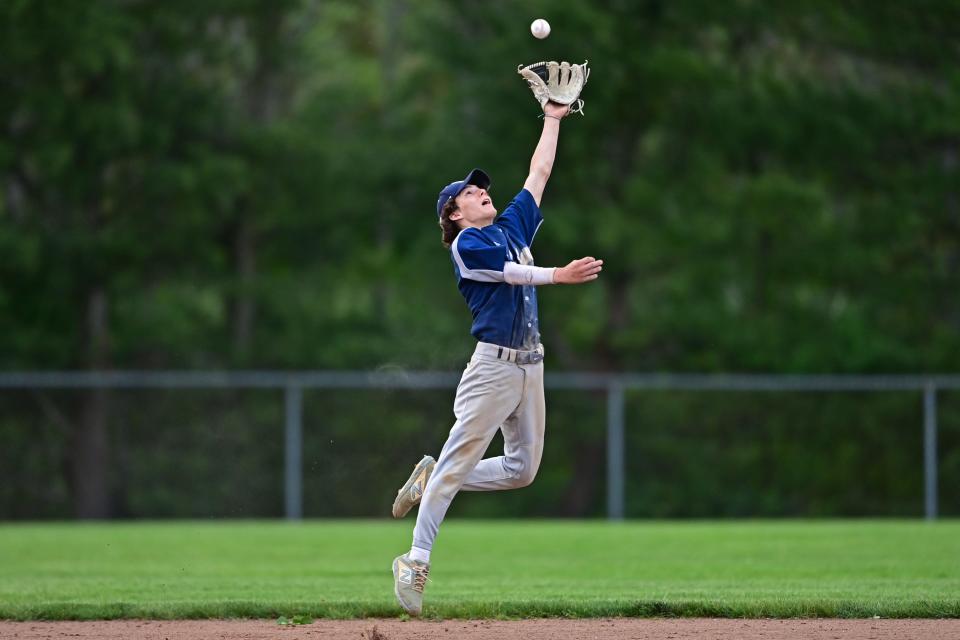 Rootstown's Jake Cultrona leaps in an attempt to take a hit away from Mooney's J.J. Stevens in the fifth inning of Monday's district semifinal against Cardinal Mooney at Cene Park in Struthers.
