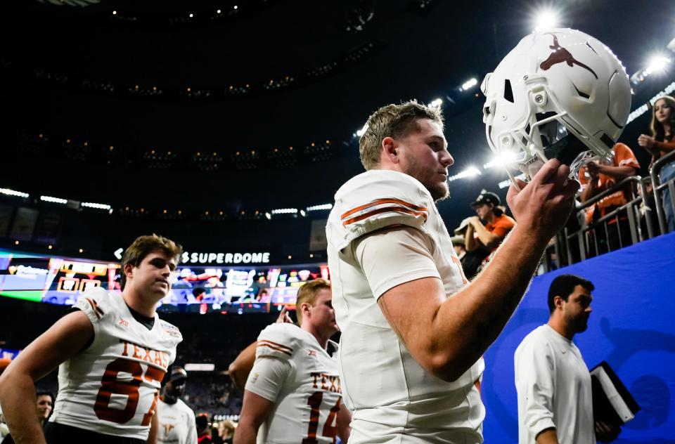 Texas quarterback Quinn Ewers signs an autograph on his way to the locker room after the Longhorns' 37-31 loss to Washington late Monday night in the Sugar Bowl. It was a challenging night for the Texas offense, though Ewers nearly rallied the Longhorns in the closing minutes.