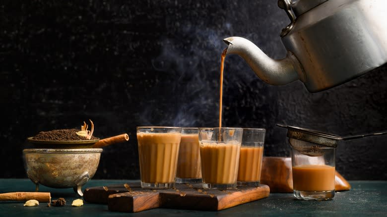 pouring chai tea into mug