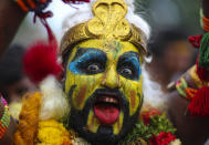 A devotee of Hindu goddess Kali performs a ritual during the 'Bonalu' festival at the Golconda Fort in Hyderabad, India, Sunday, July 11, 2021. Bonalu is a month-long Hindu folk festival of the Telangana region dedicated to Kali, the Hindu goddess of destruction. (AP Photo/Mahesh Kumar A.)