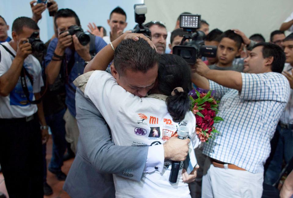 In this photo taken on Friday, Oct. 19, 2012, Olga Marina Hernandez, a member of the Convoy of Central American Mothers, embraces her son Gabriel Salmeron, in Escobedo, Mexico. The convoy mostly comprised of women from Central America, travel 2,800 miles through Mexico to search for their relatives who left for a better life and then disappeared on their journey to the U.S. Hernandez, 52, of Honduras, came last year looking with the convoy for her 31-year-old son whom she hadn’t heard from since he left five years earlier. Salmeron's girlfriend saw the photograph the mother was carrying when it was published in the local press and mother and son were reunited. About 100 have been reunited through similar trips through Mexico over six years. (AP Photo)