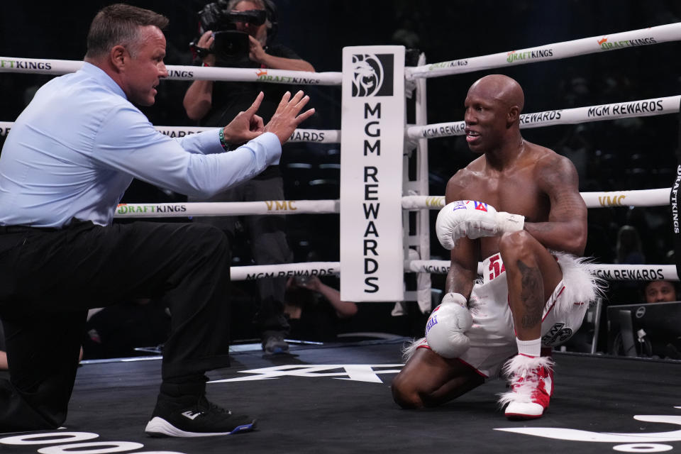 The referee counts as Yordenis Ugas kneels after being knocked down by Mario Barrios in a welterweight boxing match Saturday, Sept. 30, 2023, in Las Vegas. (AP Photo/John Locher)
