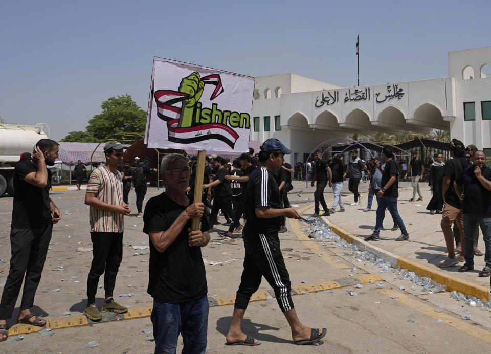 Supporters of Iraqi Shiite cleric Muqtada al-Sadr protest in front the Supreme Judicial Council, in Baghdad, Iraq, Tuesday, Aug. 23, 2022. Dozens of supporters of al-Sadr, an influential Shiite cleric in Iraq, rallied on Tuesday in Baghdad’s heavily-fortified Green Zone, demanding the dissolution of parliament and early elections. The demonstration underscored how intractable Iraq's latest political crisis has become. (AP Photo/Hadi Mizban)