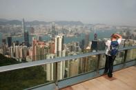 A visitor photographs the view from the Sky Terrace 428.