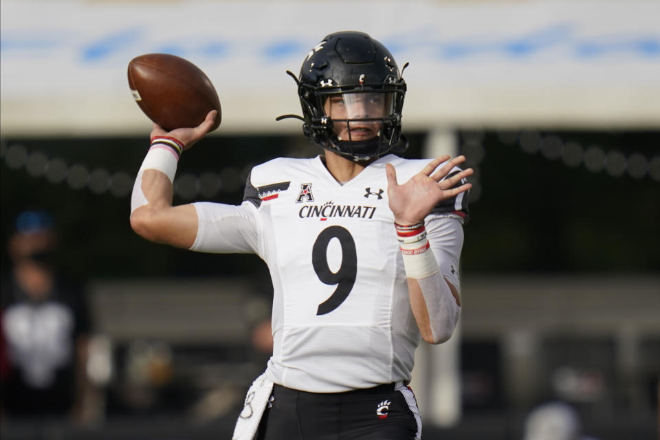 Cincinnati quarterback Desmond Ridder looks for a receiver against Central Florida during the first half of an NCAA college football game, Saturday, Nov. 21, 2020, in Orlando, Fla. (AP Photo/John Raoux)