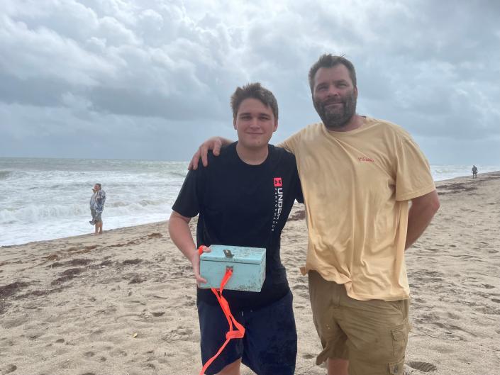 Robert Harrod IV, left,  and his father, Robert Harrod III found a mini treasure chest washed up in the tide at Jensen Beach.