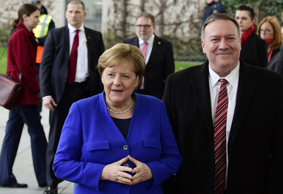 German Chancellor Angela Merkel, left, greets U.S. Secretary of State Mike Pompeo during arrivals for a conference on Libya at the chancellery in Berlin, Germany, Sunday, Jan. 19, 2020. German Chancellor Angela Merkel hosts the one-day conference of world powers on Sunday seeking to curb foreign military interference, solidify a cease-fire and help relaunch a political process to stop the chaos in the North African nation. (AP Photo/Jens Meyer)