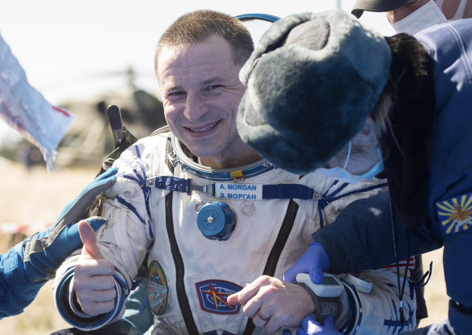 In this handout photo released by Gagarin Cosmonaut Training Centre (GCTC), Roscosmos space agency, U.S. astronaut Andrew Morgan gestures shortly after the landing of the Russian Soyuz MS-15 space capsule near Kazakh town of Dzhezkazgan, Kazakhstan, Friday, April 17, 2020. An International Space Station crew has landed safely after more than 200 days in space. The Soyuz capsule carrying NASA astronauts Andrew Morgan, Jessica Meir and Russian space agency Roscosmos' Oleg Skripochka touched down on Friday on the steppes of Kazakhstan. (Andrey Shelepin, Gagarin Cosmonaut Training Centre (GCTC), Roscosmos space agency, via AP)