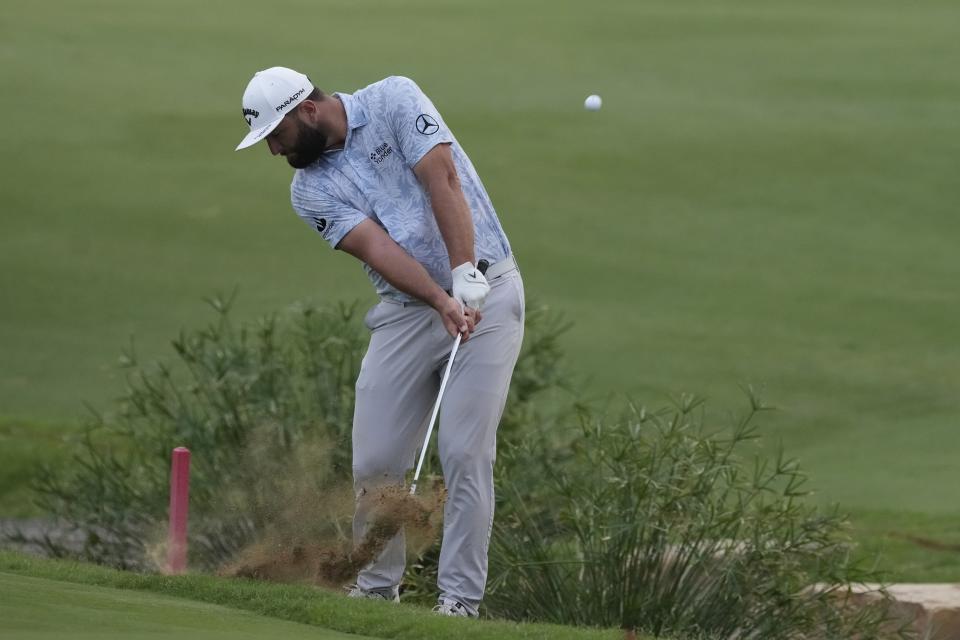 Jon Rahm from Spain plays his third shot on the 18th hole during the round one of the DP World Tour Championship golf tournament, in Dubai, United Arab Emirates, Thursday, Nov. 16, 2023. (AP Photo/Kamran Jebreili)
