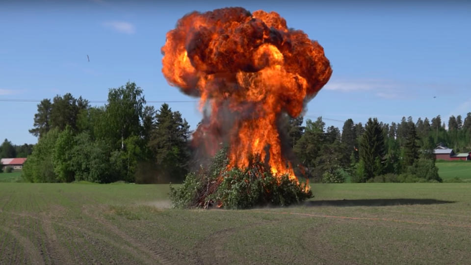 A gasoline bonfire in the midst of exploding into a massive, flaming mushroom cloud.