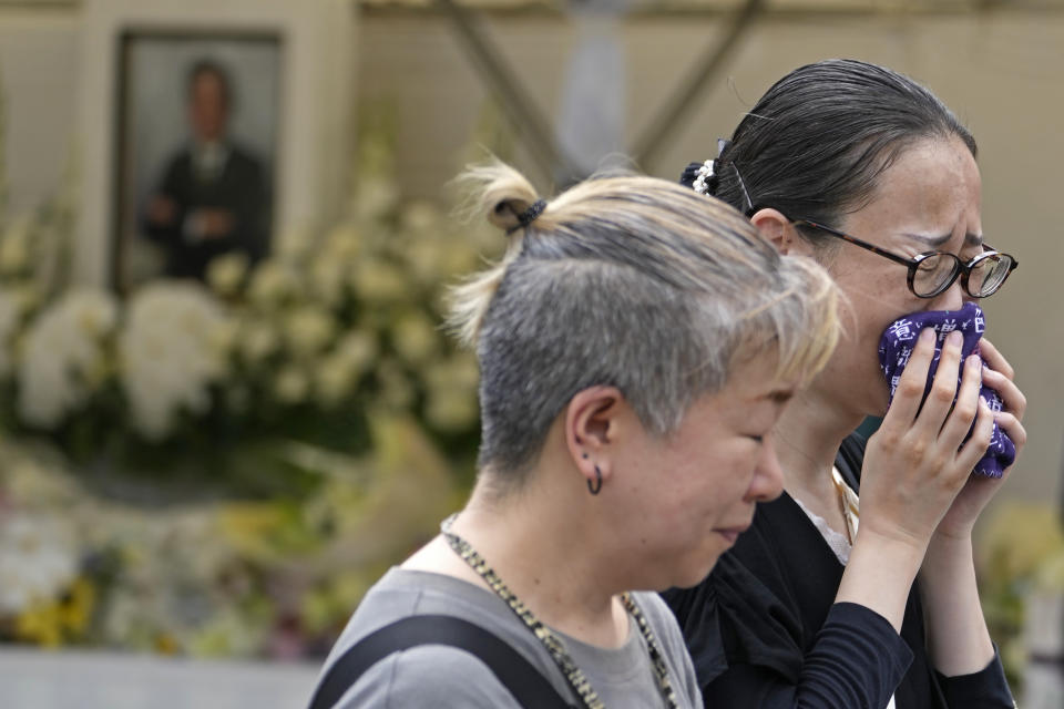 People react after offering prayer for former Prime Minister Shinzo Abe at Zojoji temple in Tokyo, Japan, Saturday, July 8, 2023. Japan marked first anniversary of the death of Abe who was shot while giving an outdoor campaign speech.(AP Photo/Shuji Kajiyama)