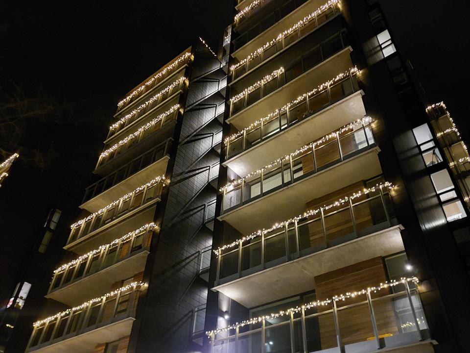 Strings of gold fairy lights on an apartment block in Reykjavik