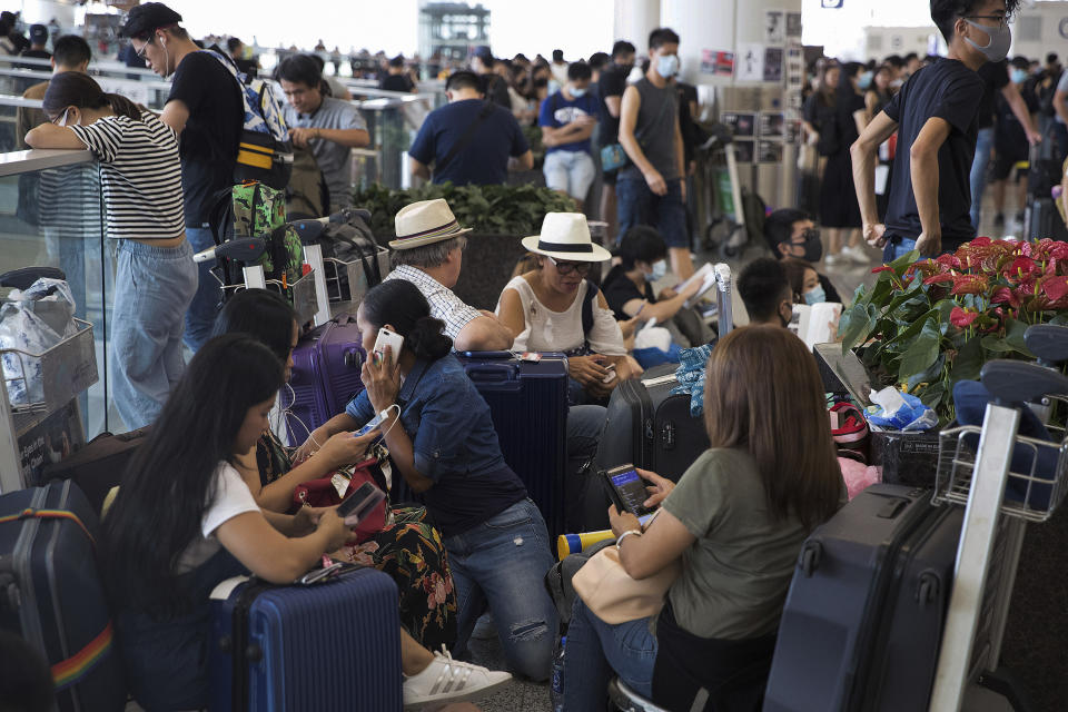 Stranded travelers wait in the departure hall of the Hong Kong International Airport in Hong Kong, Tuesday, Aug. 13, 2019. (Photo: Vincent Thian/AP)