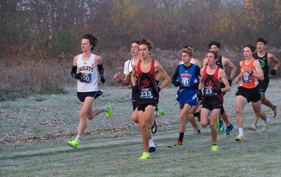St. Johns senior, Joey Bowman (233) is out front with Haslett's Nate Carmody (100) in the D2 Boys Regional Cross Country race Saturday, Oct. 29, 2022. Bowman went on to place first with Carmody taking second.