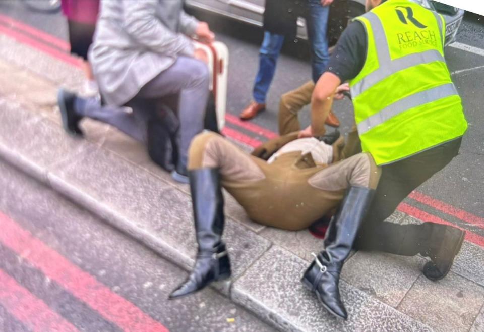 An injured cavalryman being treated by emergency services after Household Cavalry horses bolted through central London smashing into vehicles (LBC News)