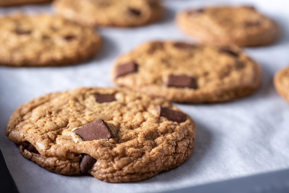 Freshly baked chocolate chip cookies cooling on a tray