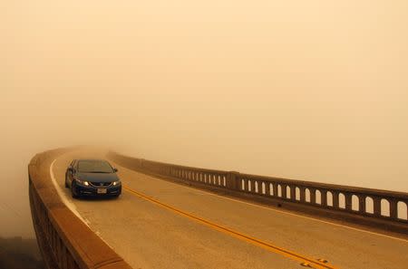 Smoke from the Soberanes Fire combined with a marine layer reduces visibility over Bixby Bridge on State Route 1 north of Big Sur, California, July 26, 2016. REUTERS/Michael Fiala