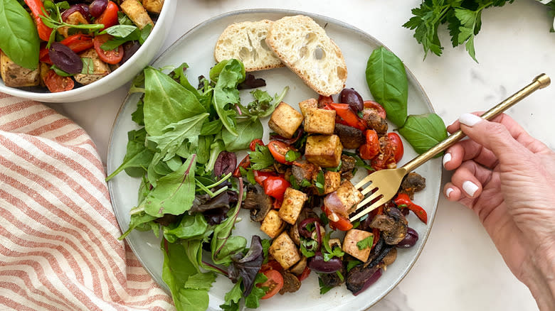 Tofu on plate with salad and bread