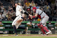 St. Louis Cardinals catcher Yadier Molina, right, loses his mask as he tags Pittsburgh Pirates' Colin Moran who tried to score from second on a hit by Kevin Newman in the eighth inning of a baseball game, Friday, Aug. 27, 2021, in Pittsburgh. (AP Photo/Keith Srakocic)