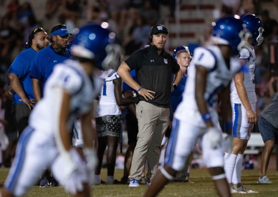 Wildcats head coach Ryan Onkka keeps his eye on the action during the Booker T. Washington vs Tate football Kickoff Classic at Tate High School in Cantonment on Thursday, Aug. 17, 2023.