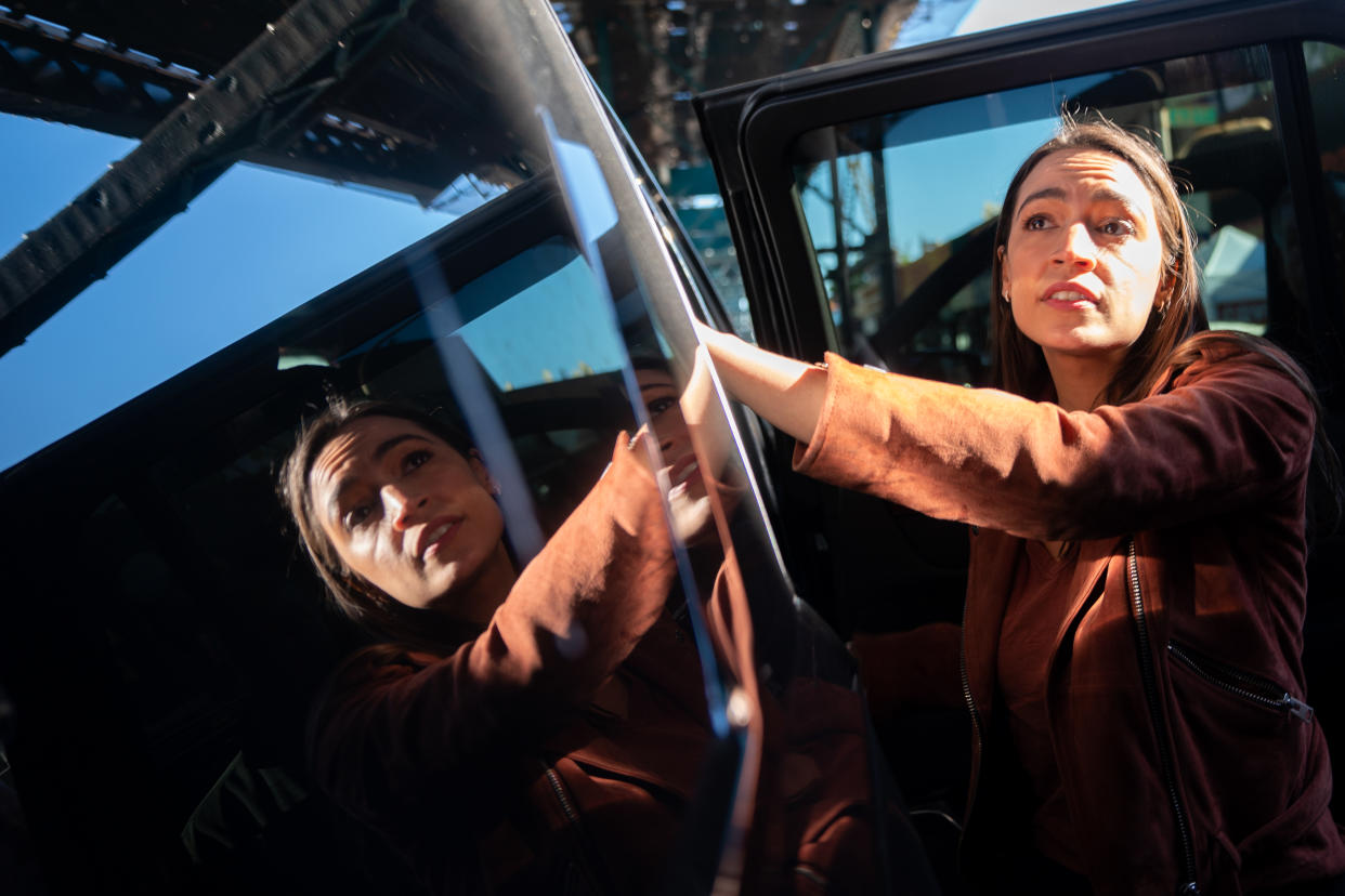 Representative Alexandria Ocasio-Cortez entering an SUV.