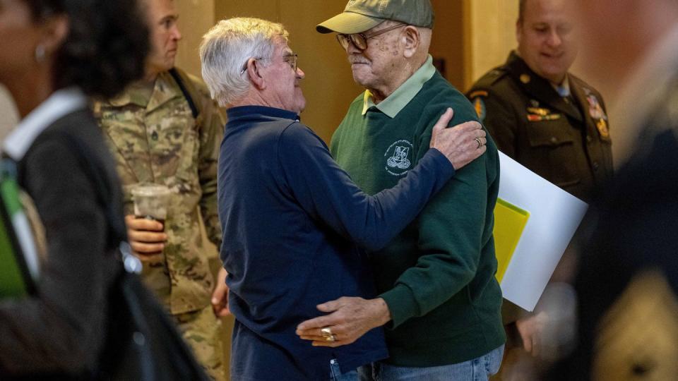 Retired Army Col. Paris Davis, an Ohio native, who is set to receive the Medal of Honor for his service in the Vietnam War, hugs his friend Jim Moriarty before sitting down for an interview with the Associated Press at a hotel in Arlington, Va., Thursday, March 2, 2023. (Andrew Harnik/AP)