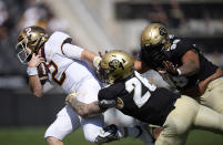 Minnesota quarterback Tanner Morgan, left, is dragged down by Colorado linebacker Carson Wells and defensive lineman Jalen Sami in the second half of an NCAA college football game Saturday, Sept. 18, 2021, in Boulder, Colo. Minnesota won 30-0. (AP Photo/David Zalubowski)