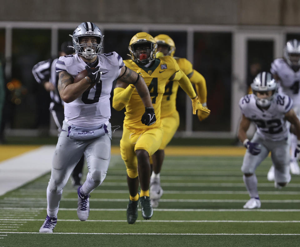Kansas State tight end Briley Moore, left, sprints past Baylor safety Christian Morgan during the second half of an NCAA college football game Saturday, Nov. 28, 2020, in Waco, Texas. (Rod Aydelotte/Waco Tribune Herald via AP)