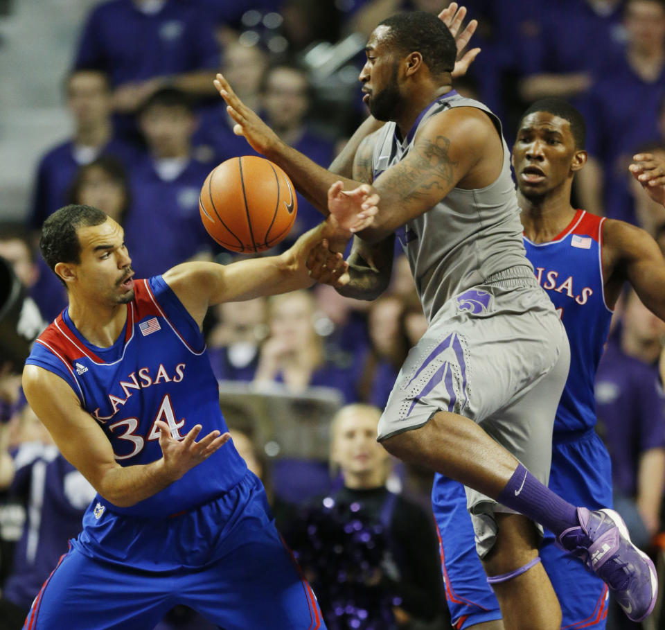 Kansas forward Perry Ellis (34) strips the ball from Kansas State forward Thomas Gipson during the first half of an NCAA college basketball game in Manhattan, Kan., Monday, Feb. 10, 2014. (AP Photo/Orlin Wagner)