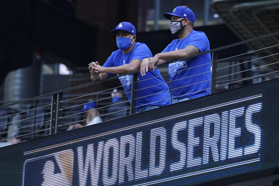 Los Angeles Dodgers fans watch batting practice before Game 2 of the baseball World Series against the Tampa Bay Rays Wednesday, Oct. 21, 2020, in Arlington, Texas. (AP Photo/Eric Gay)