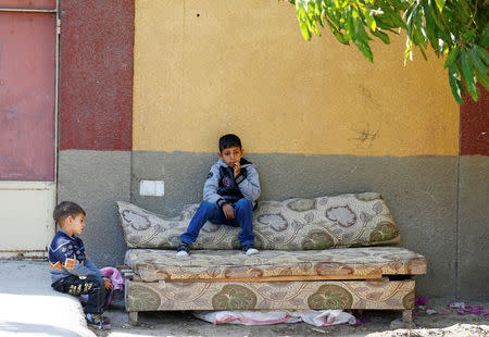 Children from families who fled their homes in Arish sit outside a rented apartment on the edge of Suez Canal in Ismailia, Egypt, April 24, 2017. Picture taken April 24, 2017. REUTERS/Mohamed Abd El Ghany