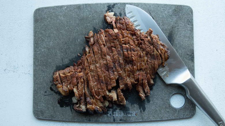 sliced steak on cutting board