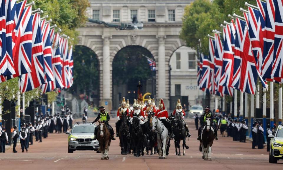 Members of the Household Cavalry make their way along the Mall in London ahead of the coffin carrying Queen Elizabeth II.