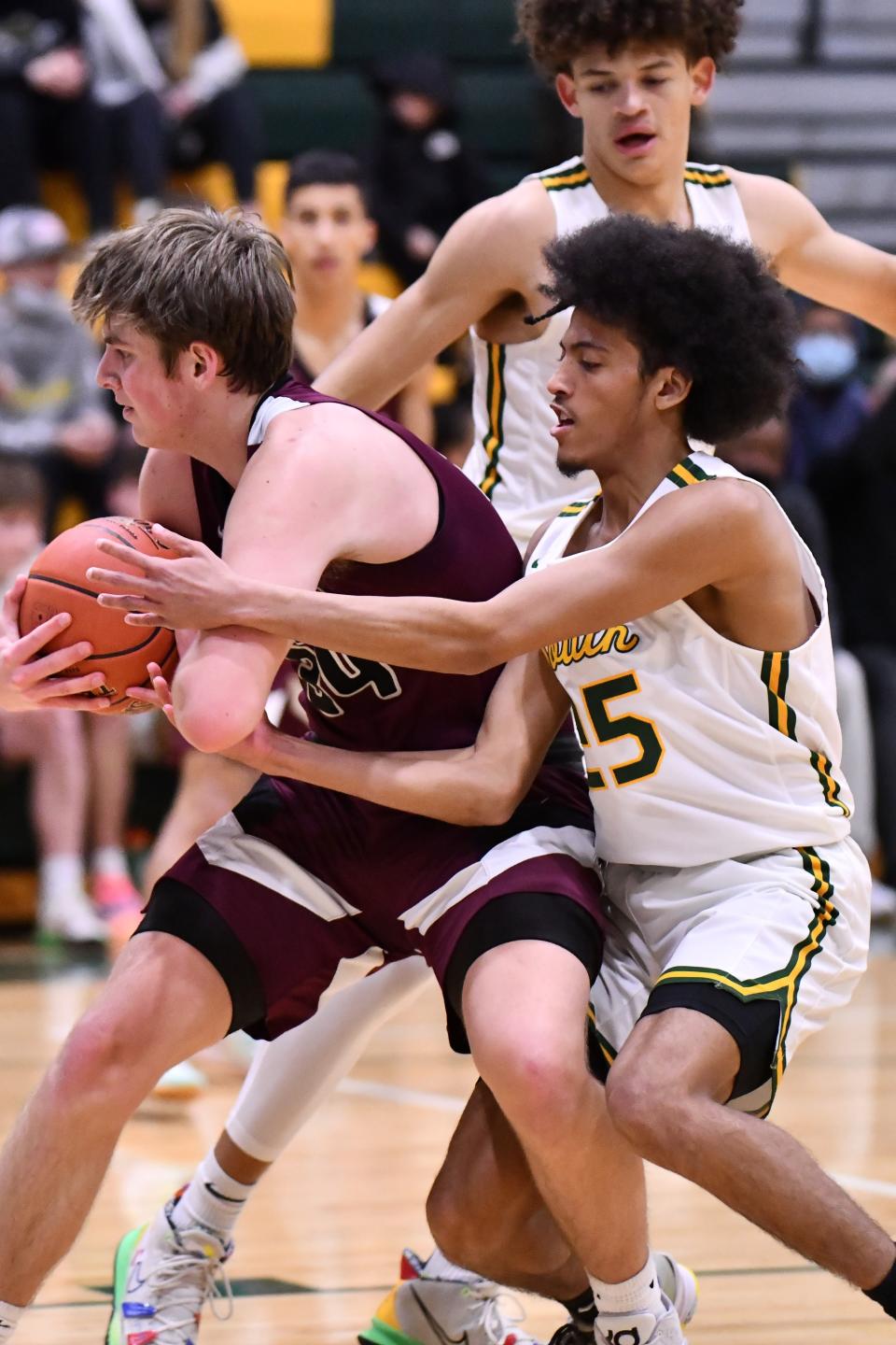 Buhler's Jack Voth (34)  is fouled by Salina South guard Quevon Purucker (25) on Thursday night in the first round of the Salina Invitational Tournament at the South gym.