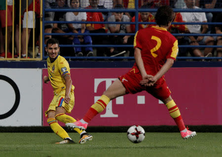 Soccer Football - 2018 World Cup Qualifications - Europe - Montenegro vs Romania - Podgorica, Montenegro - September 4, 2017 - Romania's Romario Benzar in action with Montenegro's Filip Stojkovic. REUTERS/Stevo Vasiljevic